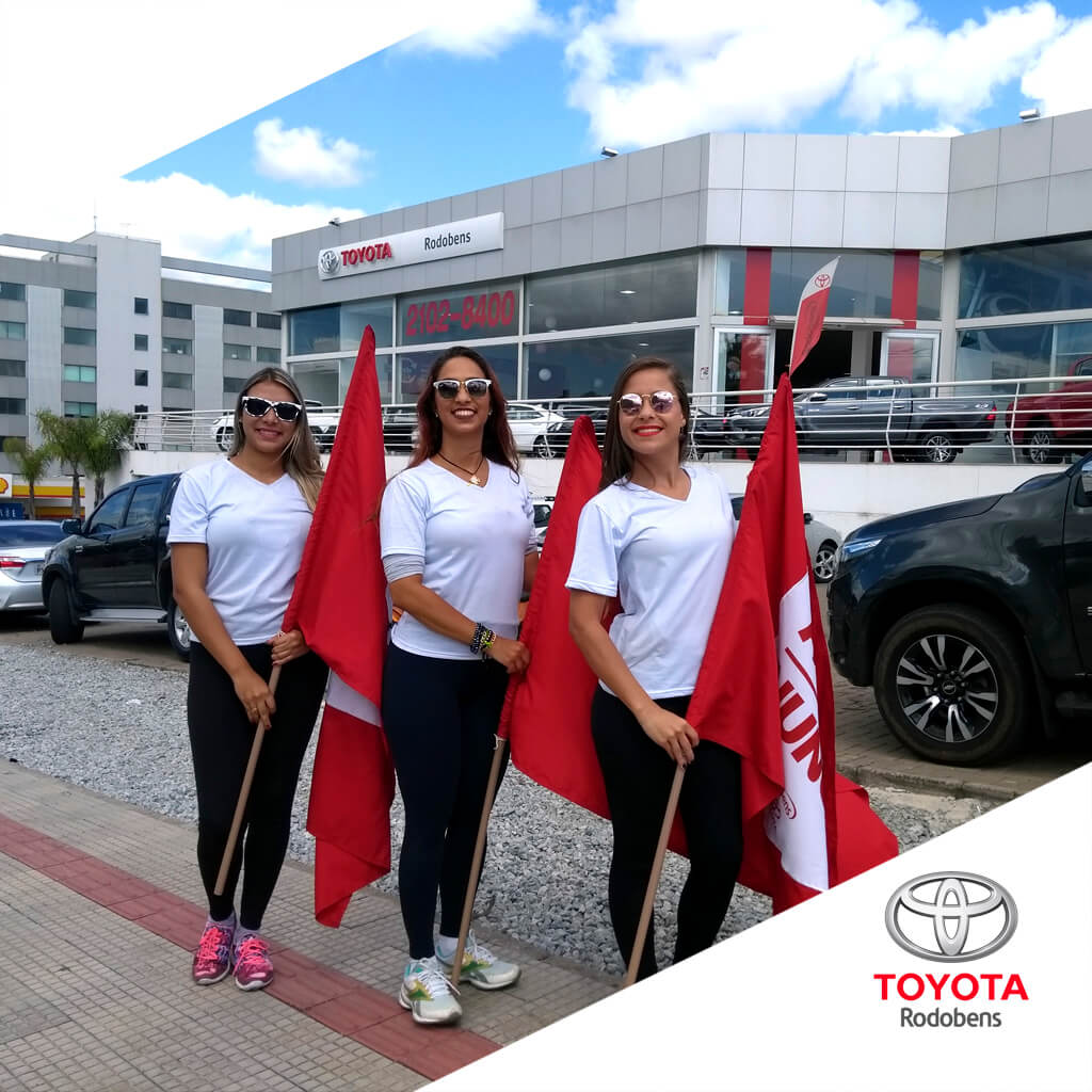 Promotoras da Toyota Rodobens segurando bandeiras